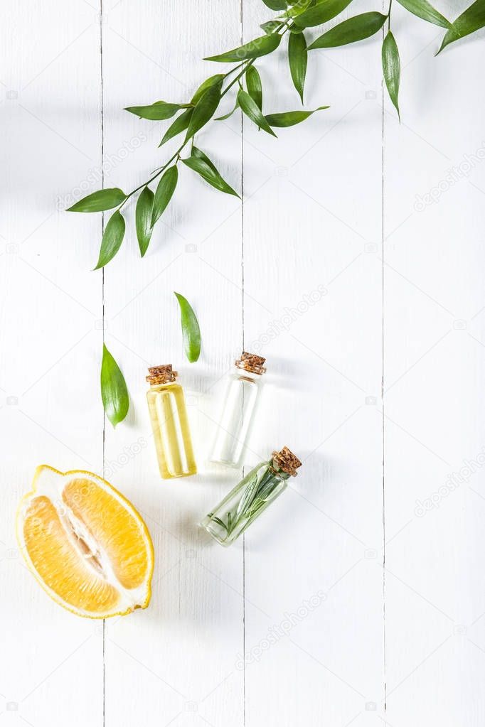Lemon oil isolated on white wooden table