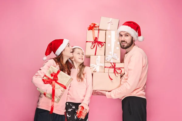 Father and mother give gifts to little daughter at studio — Stock Photo, Image