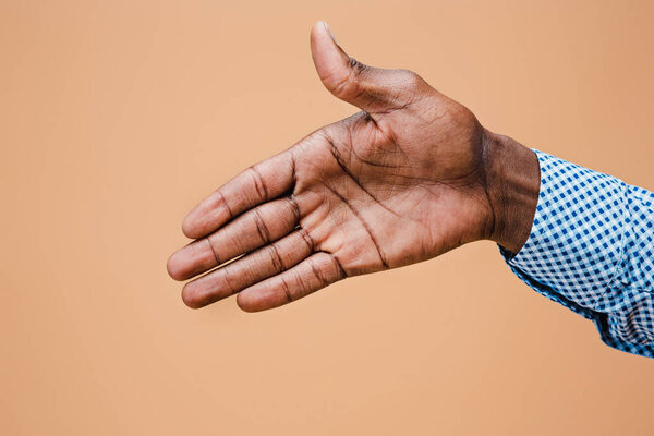 Handshake. Hands of businessman isolated on brown background
