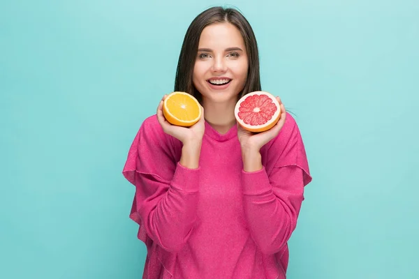 Beautiful womans face with juicy orange — Stock Photo, Image