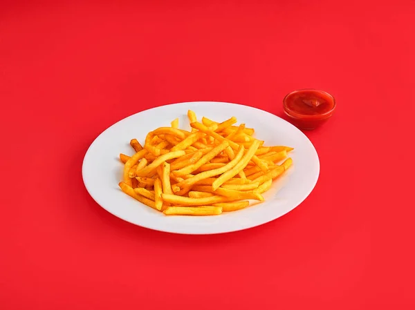 Papas fritas en un plato, aisladas sobre fondo rojo — Foto de Stock