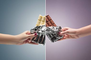 Hands of a woman holding a tile of chocolate clipart