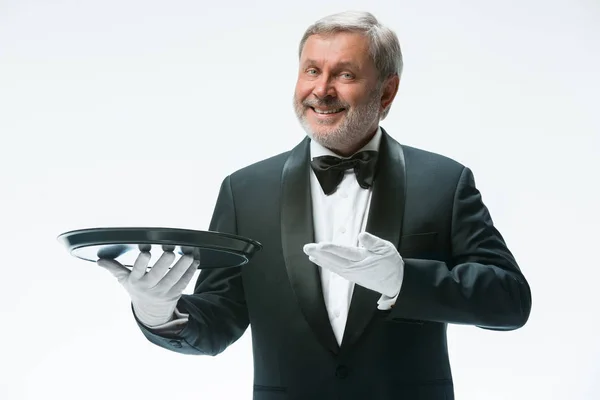 Senior waiter holding tray — Stock Photo, Image