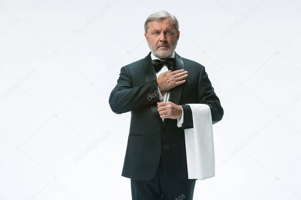 Senior waiter with white towel. Sign language in the restaurant