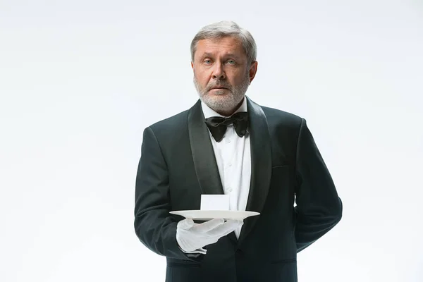 Senior waiter holding tray — Stock Photo, Image