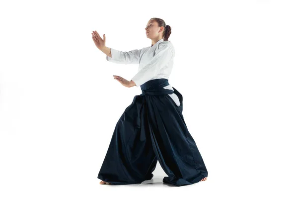 Aikido master praktijken verdediging houding. Gezonde levensstijl en sport concept. Vrouw in witte kimono op witte achtergrond. — Stockfoto