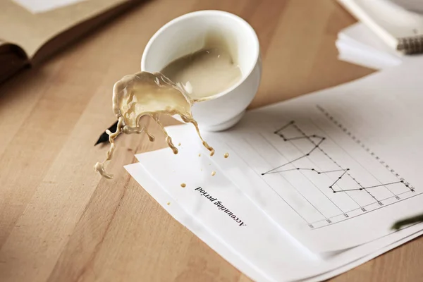 Coffee in white cup spilling on the table in the morning working day at office table — Stock Photo, Image