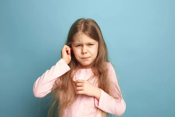 Kulak ağrısı. Genç kız mavi bir arka plan üzerinde. Yüz ifadeleri ve insan duyguları kavramı — Stok fotoğraf