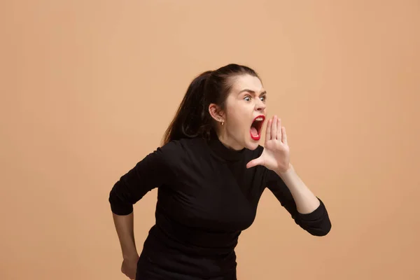 The young emotional angry woman screaming on pastel studio background — Stock Photo, Image