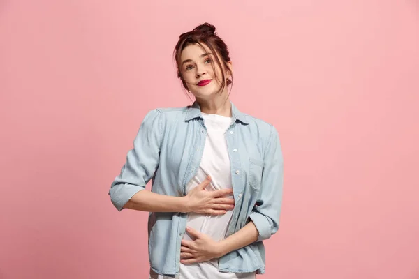 A mulher de negócios feliz de pé e sorrindo contra fundo rosa . — Fotografia de Stock