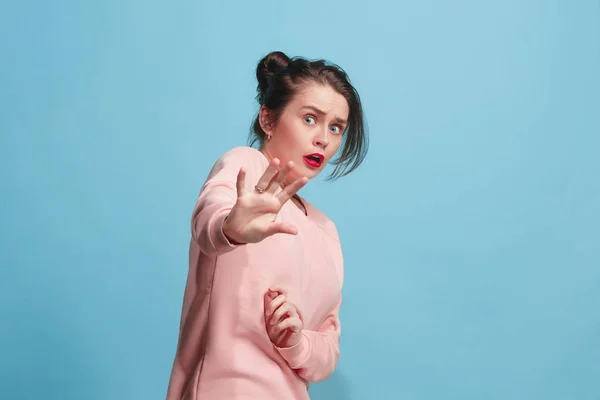 Portrait of the scared woman on blue — Stock Photo, Image