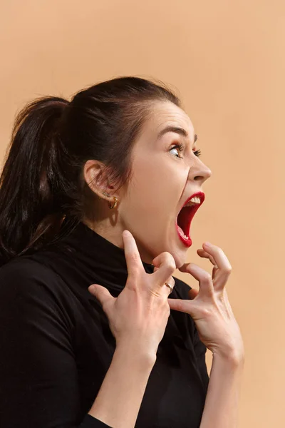 A jovem mulher irritada emocional gritando no fundo do estúdio pastel — Fotografia de Stock