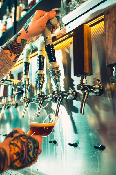 Mano de cantinero vertiendo una gran cerveza lager en el grifo . — Foto de Stock