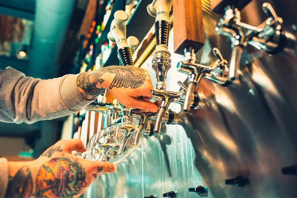 Hand of bartender pouring a large lager beer in tap. — Stock Photo, Image