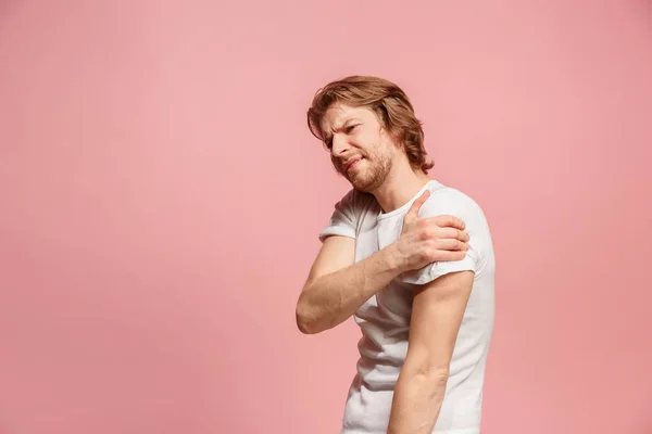 Young man overwhelmed with a pain in the stomach . — Stock Photo, Image