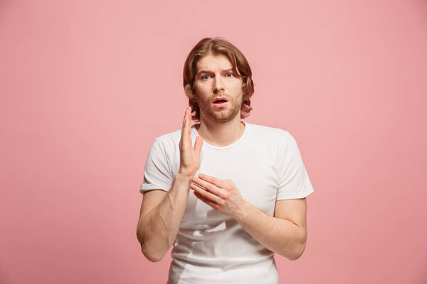 Let me think. Doubtful pensive man with thoughtful expression making choice against pink background