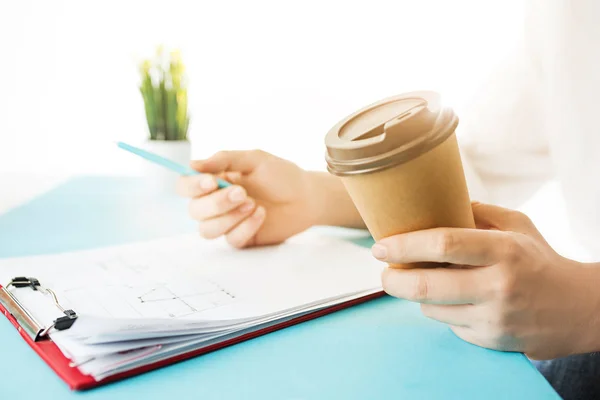 남성 손 들고 펜과 커피입니다. 트렌디한 블루 책상. — 스톡 사진