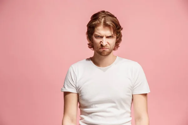 Portrait of an angry man looking at camera isolated on a pink background — Stock Photo, Image