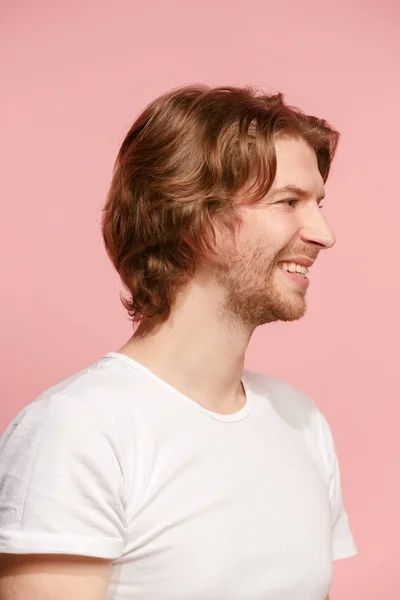 O empresário feliz de pé e sorrindo contra fundo rosa . — Fotografia de Stock