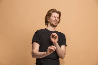 Genç adam tiksinti ifadesi üzerine pastel izole bir şey geçirmeyen