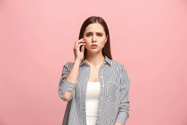 Let me think. Doubtful pensive woman with thoughtful expression making choice against pink background