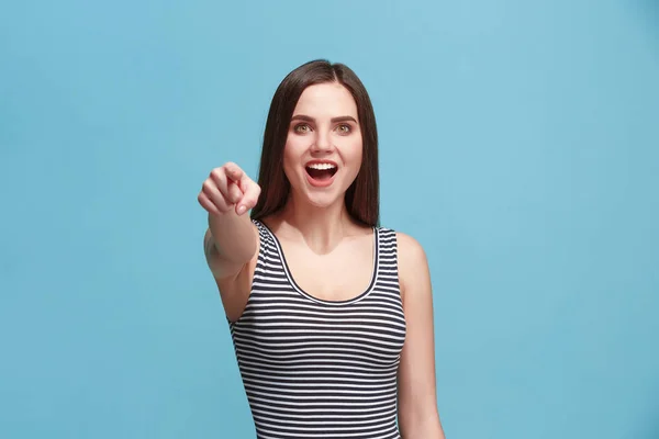 The happy woman point you and want you, half length closeup portrait on blue background.