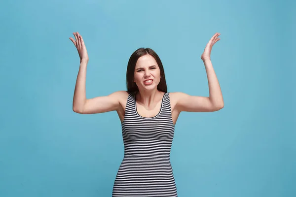 Portrait of an angry woman looking at camera isolated on a blue background — Stock Photo, Image
