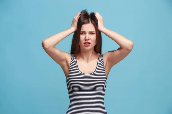 Woman having headache. Isolated over pastel background.