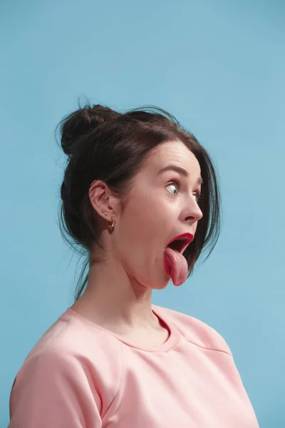 The squint eyed woman with weird expression isolated on blue — Stock Photo, Image