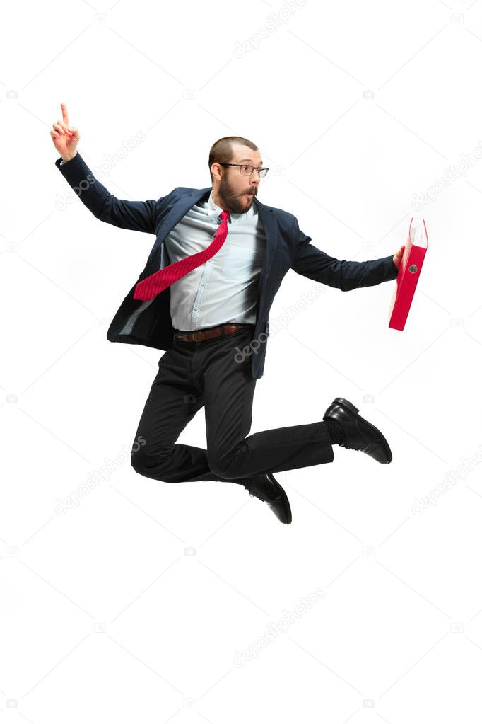 Funny cheerful businessman jumping in air over white background