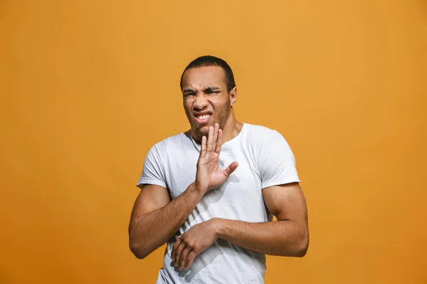 The young man whispering a secret behind her hand over orange background — Stock Photo, Image