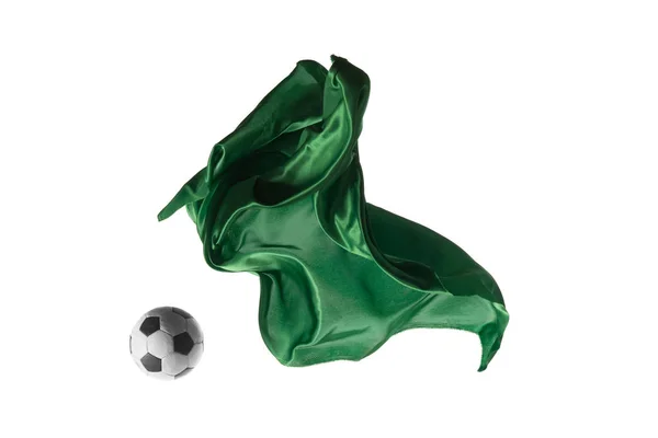 Fußball und glatte elegante transparente grüne Tuch isoliert oder getrennt auf weißem Studiohintergrund. — Stockfoto