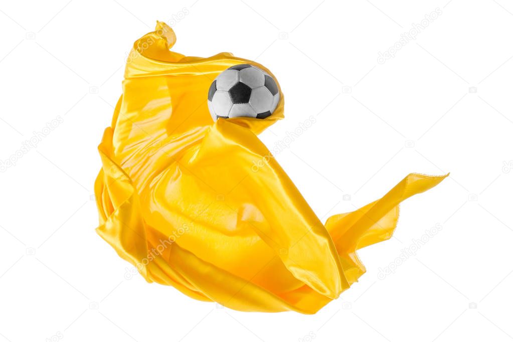 Soccer ball and Smooth elegant transparent yellow cloth isolated or separated on white studio background.