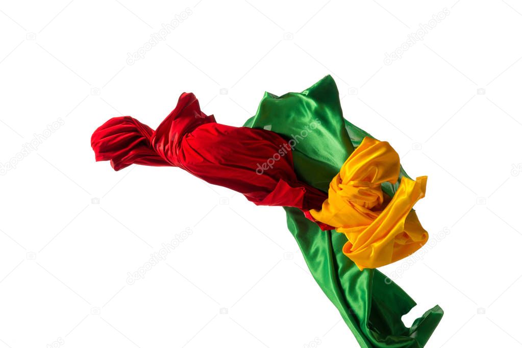 Smooth elegant transparent yellow, red, green cloth separated on white background.