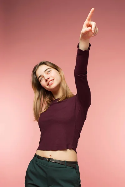 Woman smiling with perfect smile and white teeth on the pink studio background — Stock Photo, Image