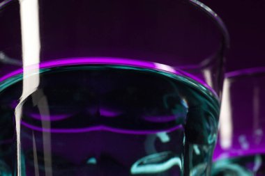 İki doldurulmuş gözlük stüdyoda masada duran şarap. Canlı parlak renkli aydınlatma. Trendy 2018 Ultra Violet ampul içinde. Mystic renk tonu ile sanat dekorasyon