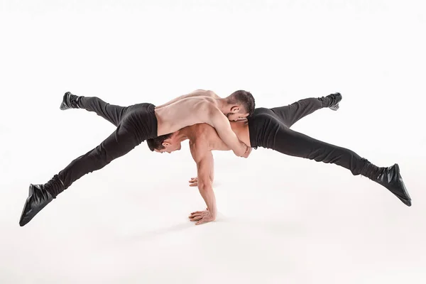 The group of gymnastic acrobatic caucasian men on balance pose — Stock Photo, Image
