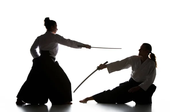 Homem e mulher lutando e treinamento aikido no fundo do estúdio branco — Fotografia de Stock