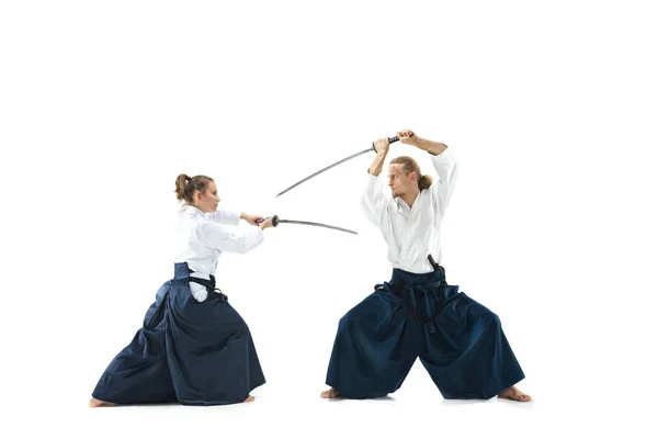 Man and woman fighting and training aikido on white studio background — Stock Photo, Image