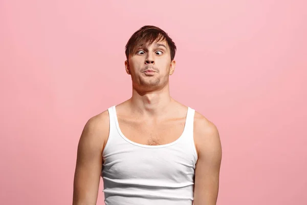 The squint eyed man with weird expression isolated on pink — Stock Photo, Image