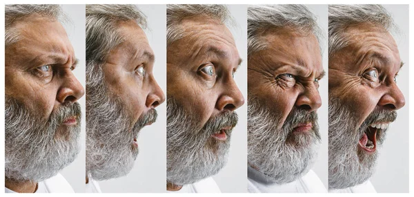 El hombre atractivo mayor mirando sorprendido aislado en blanco —  Fotos de Stock