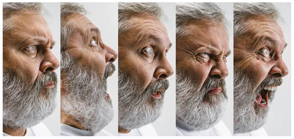 De senior aantrekkelijke man op zoek verrast geïsoleerd op wit — Stockfoto