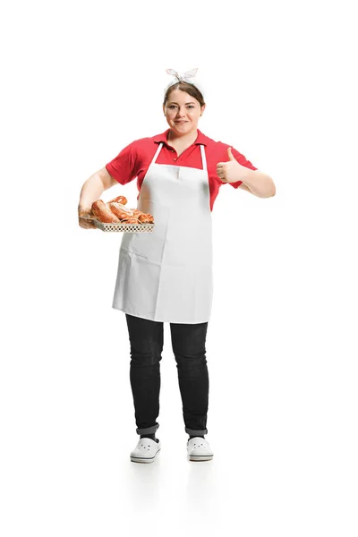 Portrait of cute smiling woman with pastries in her hands in the studio, isolated on white background — Stock Photo, Image