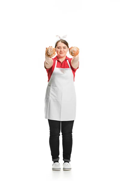 Portrait of cute smiling woman with pastries in her hands in the studio, isolated on white background — Stock Photo, Image