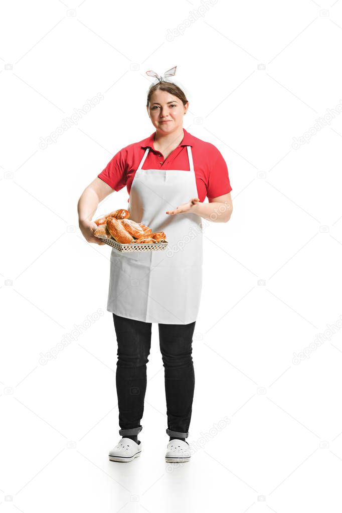 Portrait of cute smiling woman with pastries in her hands in the studio, isolated on white background
