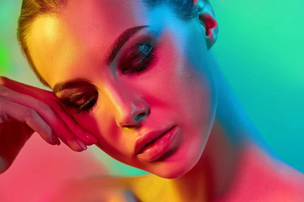 High Fashion model woman in colorful bright lights posing in studio — Stock Photo, Image