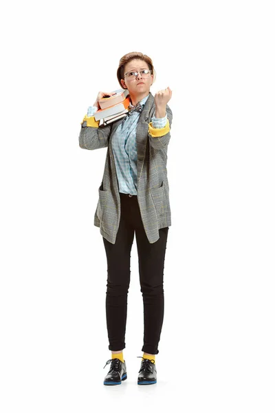 Full length portrait of a angry female student holding books isolated on white background — Stock Photo, Image