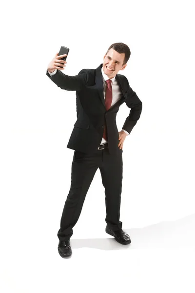 Happy businessman talking on the phone isolated over white background in studio shooting — Stock Photo, Image