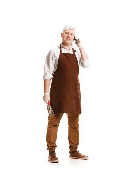 Smiling butcher posing with a cleaver isolated on white background — Stok Foto