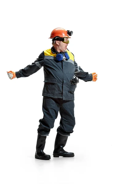 The studio shot of senior bearded male miner standing at the camera on a white background. — Stock Photo, Image